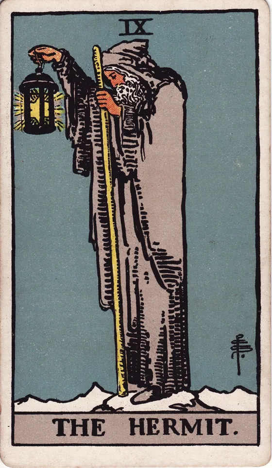 Tarotkarte Der Eremit: Ein alter Mann im grauen Mantel steht auf einem verschneiten Gipfel. Er hält eine Laterne, darin leuchtet ein Stern.